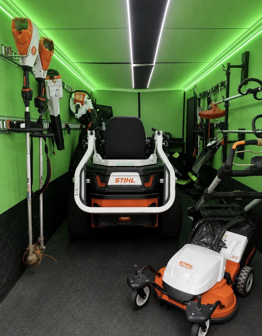 STIHL battery handheld tools racked inside the QuietScapes trailer